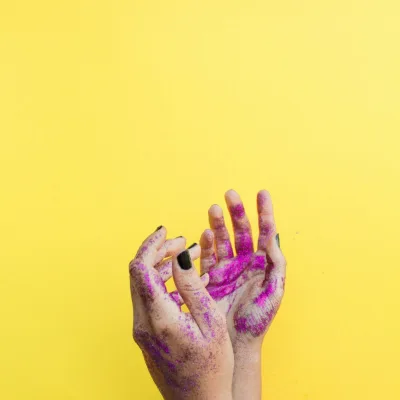 A pair of hands with finished nails, flat on the paper by the window.